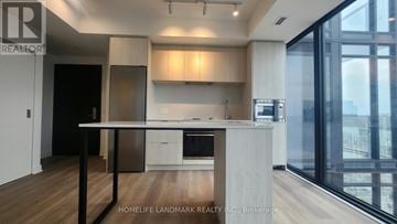 Hamilton (Beasley) condo for rent - A modern kitchen with a dining table and chairs.
