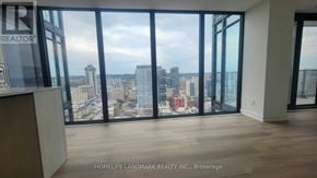 Hamilton (Beasley) condo for rent - A real estate company's office with a view of the city skyline.