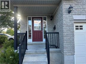 Kitchener townhouse for rent - A house with a red door and a sign that says REALTOR.
