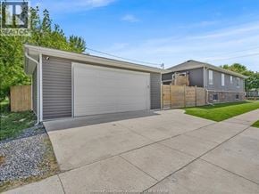 Tecumseh apartment for rent - A residential area with a detached house and a garage.