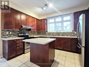 Markham (Wismer) apartment for rent - A kitchen with brown cabinets and a granite countertop.