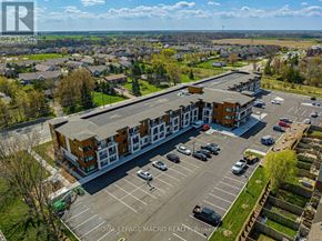 Hamilton (Binbrook) multi-family for rent - A parking lot in front of a building with the text "Royal LePage Macro Realty Brokerage" on it.