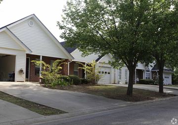 Newnan apartment for rent - A white house with a tree in front.