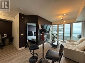 Toronto (Mimico) condo for rent - A bedroom with a large bed and a desk with a chair.