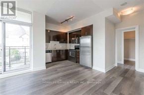 Vaughan (Beverley Glen) condo for rent - A well-lit kitchen with a refrigerator, sink, and cabinets.