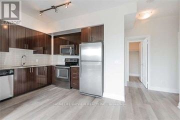 Vaughan (Beverley Glen) condo for rent - A kitchen with wooden cabinets and a white fridge.
