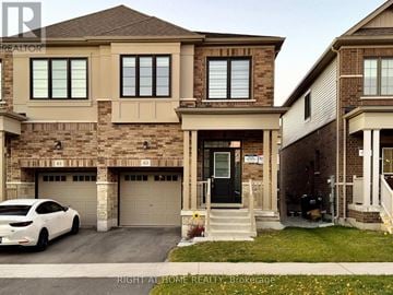 Barrie apartment for rent - A white car is parked in front of a house with a garage.
