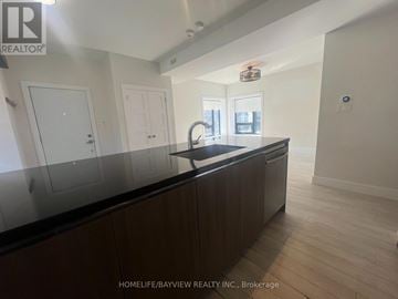 Toronto (East York) triplex for rent - A kitchen with a counter top and cabinets.