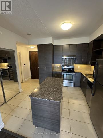 Markham (Commerce Valley) condo for rent - A kitchen with a granite counter top and stainless steel appliances.