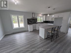 West Nipissing (Sturgeon Falls) apartment for rent - A spacious kitchen and dining area with a large island in the middle.