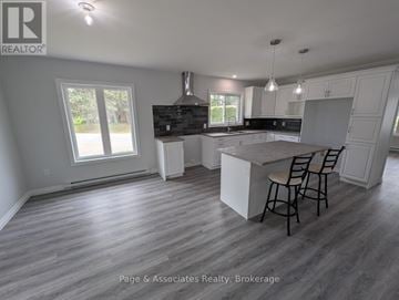 West Nipissing (Sturgeon Falls) apartment for rent - A spacious kitchen and dining area with a large island in the middle.