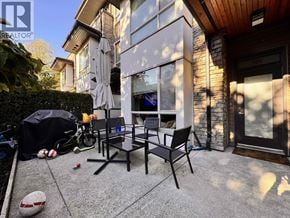 Burnaby townhouse for rent - A patio with a table and chairs and a ball.