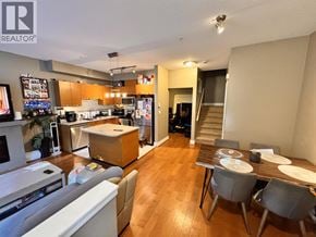 Burnaby townhouse for rent - A well-lit kitchen and dining area with wooden floors and modern furniture.