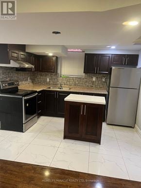 Brampton (Fletcher's Meadow) apartment for rent - A kitchen with dark brown cabinets and a white refrigerator.
