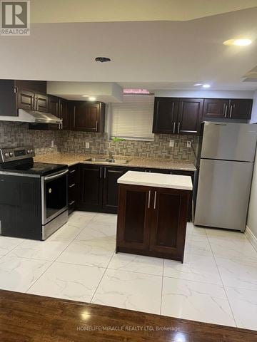 Brampton (Fletcher's Meadow) apartment for rent - A kitchen with dark brown cabinets and a white refrigerator.