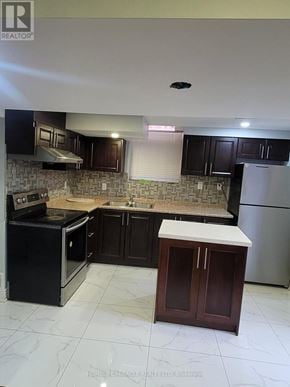 Brampton (Fletcher's Meadow) apartment for rent - A kitchen with black cabinets and a white island.