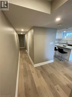 Kitchener apartment for rent - A hallway with wood flooring and white walls.
