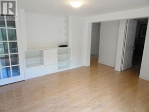 Toronto (L'amoreaux) apartment for rent - A room with wooden floors and white walls.