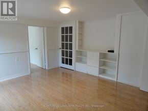 Toronto (L'amoreaux) apartment for rent - A room with a wooden floor and white walls.