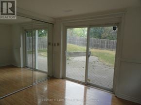 Toronto (L'amoreaux) apartment for rent - A room with a sliding glass door leading to a backyard.