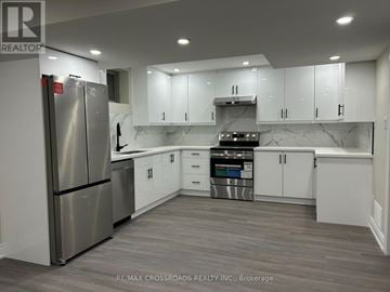 Ajax (Northwest Ajax) apartment for rent - A modern kitchen with a stainless steel refrigerator and white cabinets.