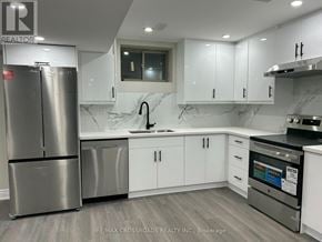 Ajax (Northwest Ajax) apartment for rent - A modern kitchen with a stainless steel refrigerator and white cabinets.