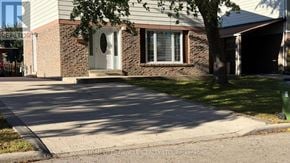 Toronto (Malvern) apartment for rent - A house with a grey roof and a white door is shown.