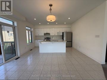 Brant (Paris) apartment for rent - A spacious kitchen with white cabinets and a large island.