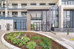 Oakville (Jm Joshua Meadows) condo for rent - A modern building with a garden in front and a sign that reads "3000".