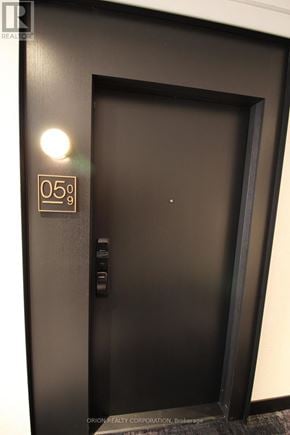 Oakville (Jm Joshua Meadows) condo for rent - A black door with a gold handle and a sign that says 05 degrees.