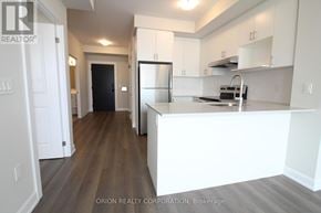 Oakville (Jm Joshua Meadows) condo for rent - A kitchen with white cabinets and a black refrigerator.