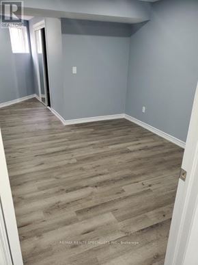 Brampton (Brampton South) apartment for rent - A room with wooden flooring and a doorway leading to another room.