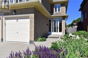 Hamilton (Kernighan) duplex for rent - A house with a white garage door and a brick facade.