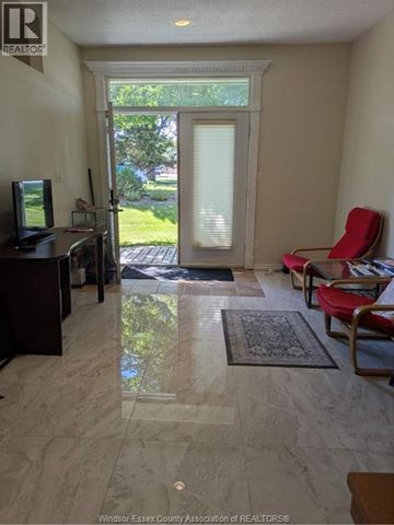 Tecumseh apartment for rent - A living room with a television and a chair.