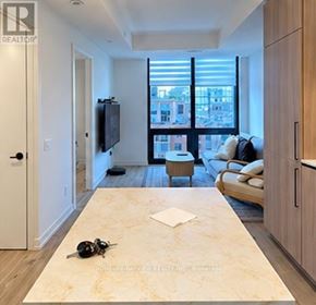 Toronto (Waterfront Communities) condo for rent - A living room with a television, a couch, and a coffee table.