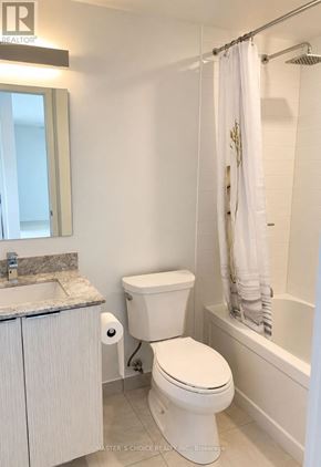 Toronto (Church-Yonge Corridor) condo for rent - A white toilet in a bathroom with a white shower curtain.