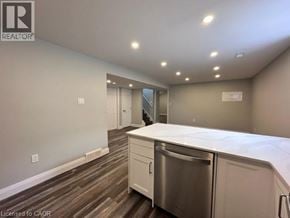 Kitchener apartment for rent - A kitchen with a stainless steel dishwasher and white countertops.