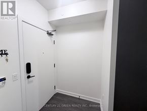 Mississauga (Central Erin Mills) condo for rent - A white door with a black handle and a key hanging on a key rack.