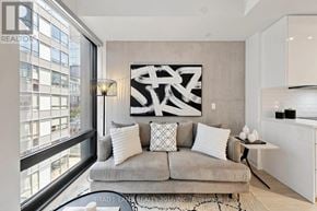 Toronto (Moss Park) condo for rent - A modern living room with a large abstract painting on the wall.