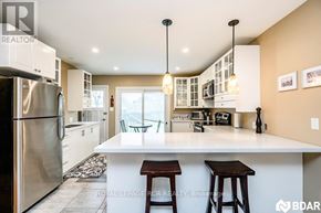 Barrie (Wellington) apartment for rent - A modern kitchen with a large island and stools.