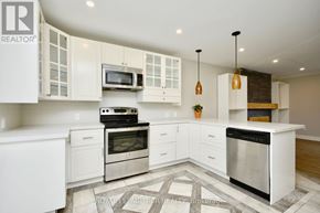 Barrie (Wellington) apartment for rent - A modern kitchen with white cabinets and stainless steel appliances.