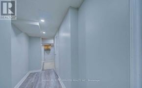 Toronto (Highland Creek) apartment for rent - A hallway with a door at the end and a sign that says "Realtor".