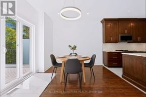 Aurora (Bayview Wellington) apartment for rent - A dining room with a table set for two and a kitchen area in the background.