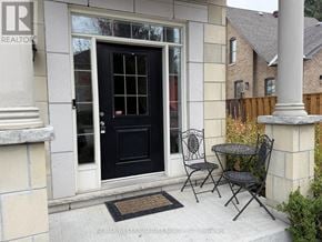 King (Nobleton) townhouse for rent - A black door with a glass window is on a white house.