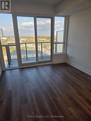 Milton (Tm Timberlea) condo for rent - A room with wooden floors and a view of the city through the windows.
