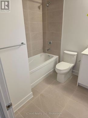 Milton (Tm Timberlea) condo for rent - A white toilet sits in a bathroom next to a bathtub.