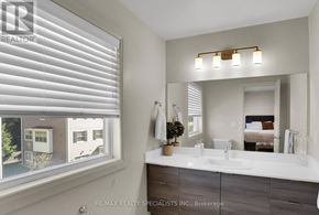 London North (North I) townhouse for rent - A bathroom with a large mirror, a sink, and a window with blinds.