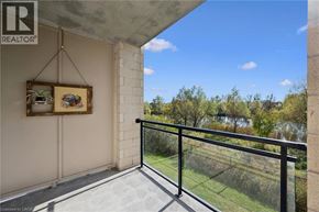 Guelph condo for rent - A balcony with a metal railing and a painting hanging on the wall.