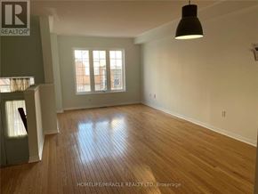 Mississauga (East Credit) townhouse for rent - A room with wooden flooring and a large window.