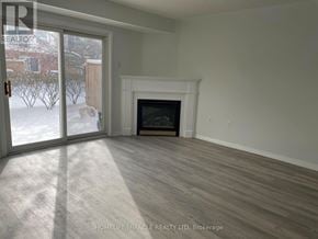 Mississauga (East Credit) townhouse for rent - A room with a fireplace and sliding glass doors.